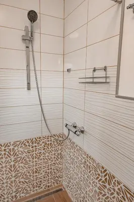 a shower in a bathroom with a glass door at July's Guest House in Primorsko