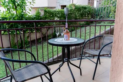a table with a bottle of wine on a balcony at Sea Time Sozopol in Sozopol