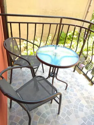 a table and two chairs and a table and a table at Guest House Sunflowers in Pomorie