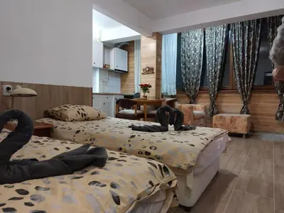 a hotel room with two beds in a room at Студио Тони in Burgas City