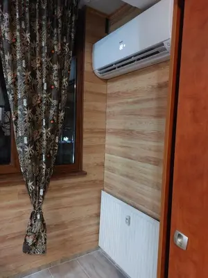 a small room with a heater and a window at Студио Тони in Burgas City