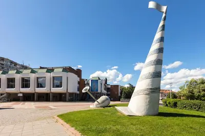 a statue of a lighthouse in front of a building at Luxury Versailles Apartments Center Opera in Burgas City