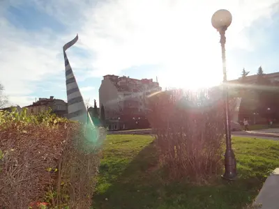 a street light and a pole in the grass at Luxury Versailles Apartments Center Opera in Burgas City