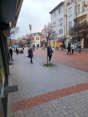 a group of people walking on a brick street at Cozy flat Sisilia center in Varna City