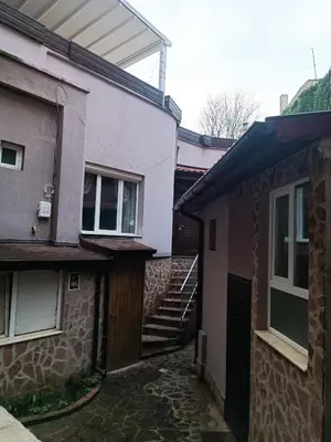 an alley between two buildings with a stairway leading to a building at Cozy flat Sisilia center in Varna City