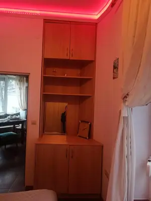 a bedroom with a red light on the ceiling at Cozy flat Sisilia center in Varna City