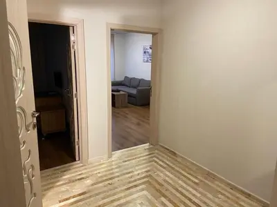 an empty room with a couch in a living room at Diamond Beach Apartment 2 Room in Burgas City