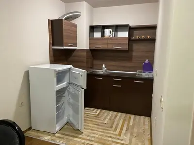 a small kitchen with a refrigerator and a sink at Diamond Beach Apartment 2 Room in Burgas City