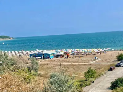 a beach with a bunch of umbrellas and the ocean at Diamond Beach Apartment 2 Room in Burgas City