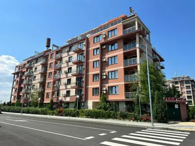 a large apartment building on the side of a street at APART SUN Travel SUNNY BEACH in Sunny Beach