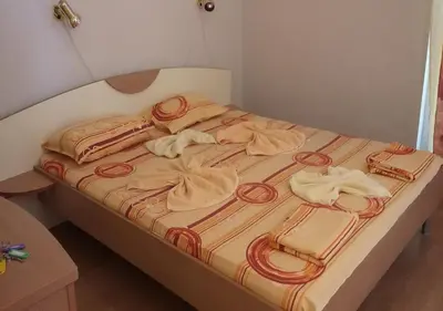 a bed with towels and bags on top of it at Complex ELIT Cacao Beach - Apartments for rent- ЕЛИТ Слънчев бряг in Sunny Beach