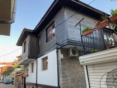 a black and white building with a balcony at GoodRest Sozopol in Sozopol