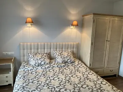 a bedroom with a bed with pillows and a cabinet at GoodRest Sozopol in Sozopol