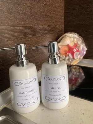 two bottles of hand soap sitting on top of a sink at Apartment Nani -Sunny beach in Sunny Beach