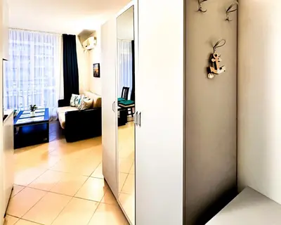 a bathroom with a mirror and a living room at Apartment Nani -Sunny beach in Sunny Beach