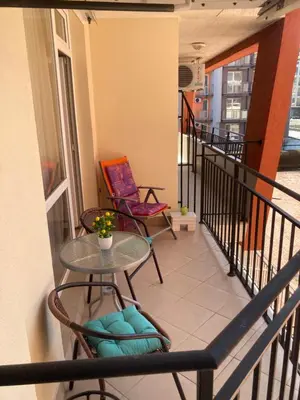 a balcony with chairs and a table on a building at Apartment Nani -Sunny beach in Sunny Beach