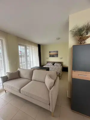 a living room with a couch and a flat screen tv at Sea View Sarafovo in Sarafovo