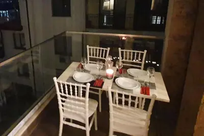 a table with four chairs and a white table and chairsktop at Апартамент Злато изглед МОРЕ in Sozopol