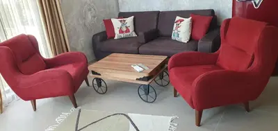 a living room with two red chairs and a couch at Апартамент Злато изглед МОРЕ in Sozopol