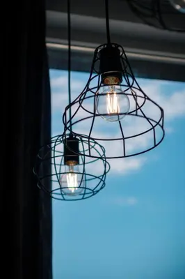 a trio of lights hanging from a window at Sky Residence Burgas with FREE Garage - Sky Apartments Burgas in Burgas City