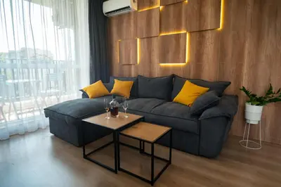 a living room with a couch and a table at Sky Residence Burgas with FREE Garage - Sky Apartments Burgas in Burgas City