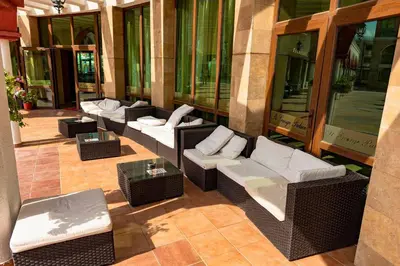 a row of wicker chairs and tables on a building at Rooftop Sea View Apartment Sveti Vlas in Sveti Vlas