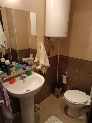 a bathroom with a sink and a toilet and a mirror at Rooftop Sea View Apartment Sveti Vlas in Sveti Vlas