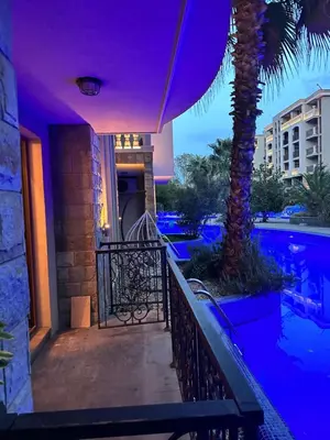 a resort with a pool and a palm tree at Studio CASCADAS FAMILY RESORT in Sunny Beach