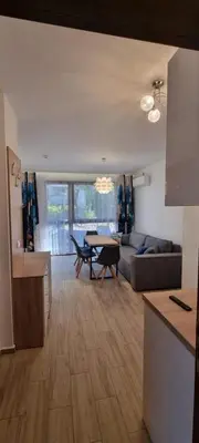 a kitchen and living room with a table and a couch at Studio CASCADAS FAMILY RESORT in Sunny Beach