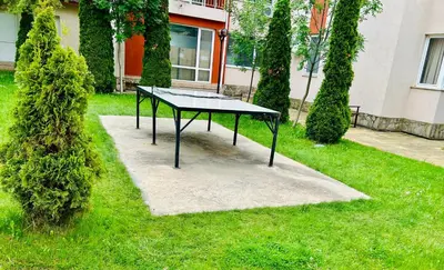 a ping pong table in the grass in a yard at Paradise View in Sunny Beach
