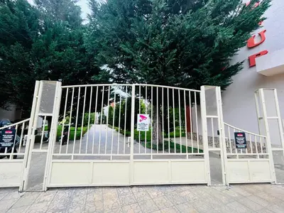 a gate in front of a building with trees at Paradise View in Sunny Beach