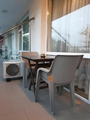 a table and chairs in a room with a window at Cozy apartment by Julie in Sunny Beach