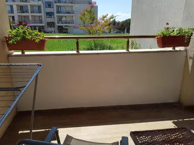 a balcony with two potted plants on a ledge at Sarafovo Sea Paradise in Burgas City