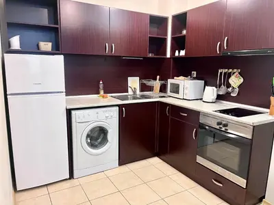 a kitchen with a washer and a sink and a dishwasher at Vadim Apartments in Panorama Beach Vigo Nessebar in Nesebar