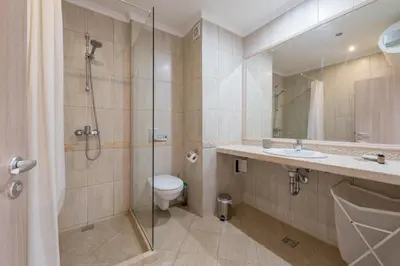 a bathroom with a shower and a toilet and a sink at Seaside Apartment in Varna City