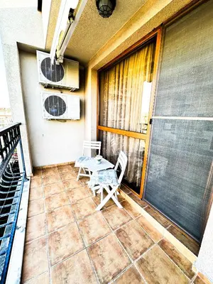 a patio with a table and chairs on a balcony at Апартамент Каскадас В54 in Sunny Beach
