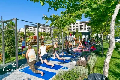 a group of people doing yoga in a park at Студио Каскадас К34 in Sunny Beach