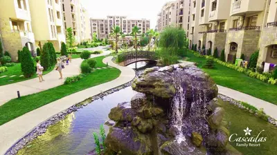 a fountain in the middle of a park with buildings at Студио Каскадас К34 in Sunny Beach