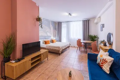 a living room with a couch and a tv at The Cozy Hub, Varna in Varna City