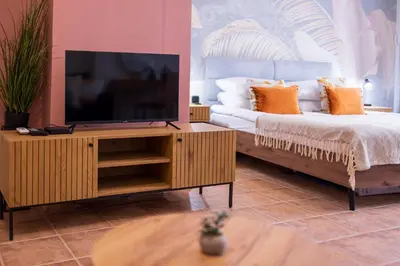 a living room with a television and a couch at The Cozy Hub, Varna in Varna City
