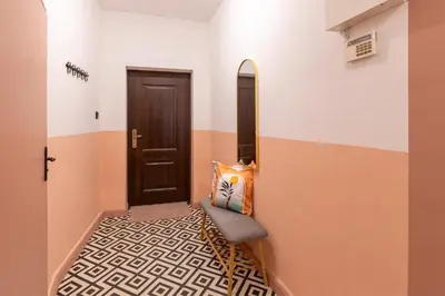a hallway with a door and a bench with a mirror at The Cozy Hub, Varna in Varna City