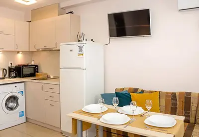 a kitchen with a table with two plates on it at Bright Studio in Top Central Location in Varna by Flat Mаnager in Varna City