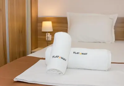a hotel room with two towels on a bed at Bright Studio in Top Central Location in Varna by Flat Mаnager in Varna City