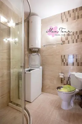 a bathroom with a toilet and a shower at Mon Tour apartments in Sunny Beach