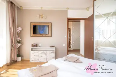 a bedroom with two beds and a mirror at Mon Tour apartments in Sunny Beach