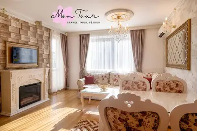 a living room with a table and chairs and a fireplace at Mon Tour apartments in Sunny Beach