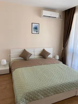 a bedroom with a bed with a green comforter at Premier Fort Beach ap. №376 section: E-3 in Sveti Vlas