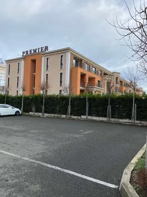 a building with a car parked in a parking lot at Premier Fort Beach ap. №376 section: E-3 in Sveti Vlas