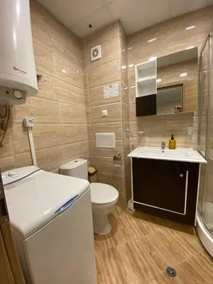 a bathroom with a toilet and a sink at Premier Fort Beach ap. №376 section: E-3 in Sveti Vlas