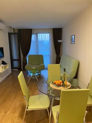 a living room with green chairs and a table and a couch at Premier Fort Beach ap. №376 section: E-3 in Sveti Vlas